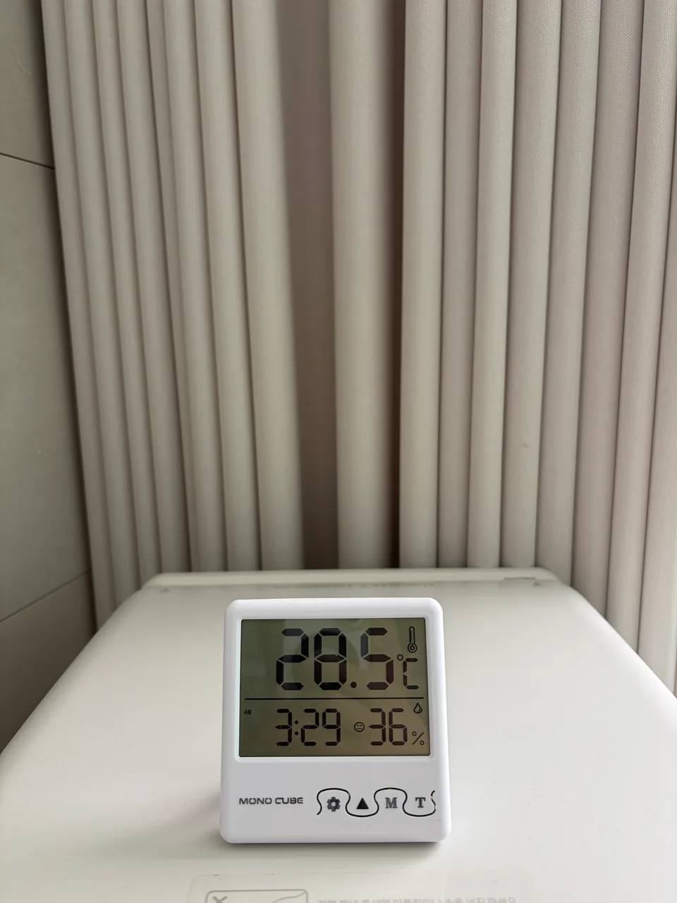 Home hygrometer on an air purifier displaying 28.5 degrees Celsius and 36% relative humidity
